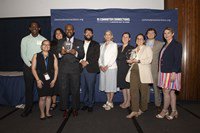 Ten individuals stand in front of a Commuter Connections banners after having received their awards