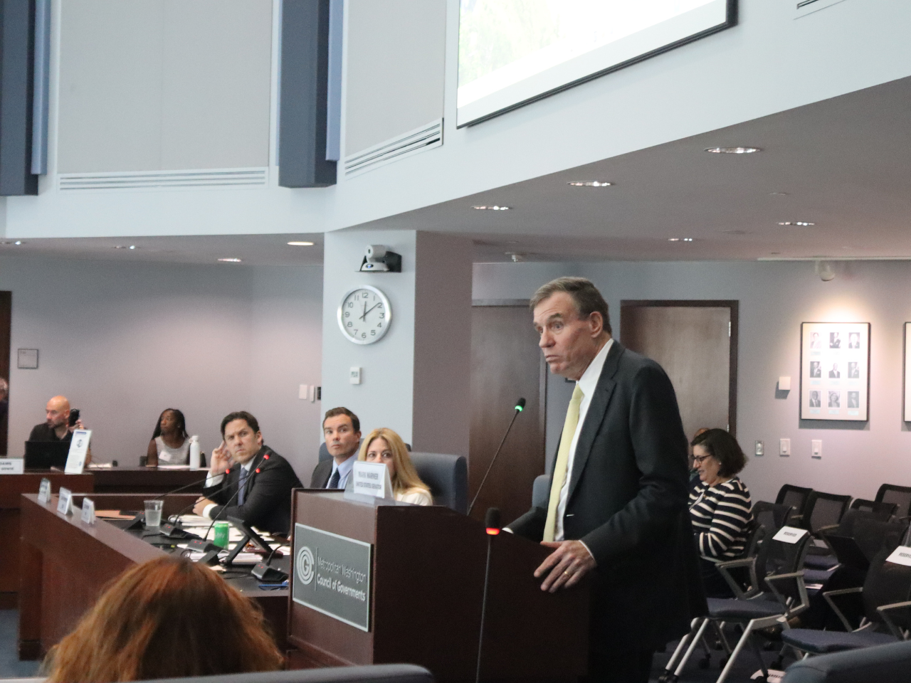U.S. Senator Mark Warner addresses COG Board members from the podium