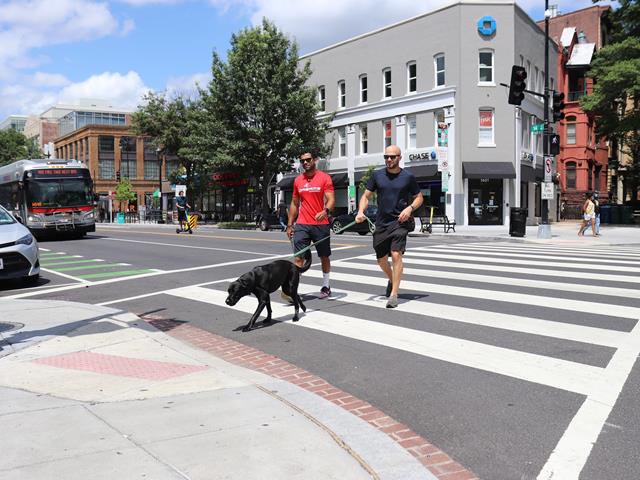 Two men crossing street at 14th Street and Rhode Island Avenue NW in Washington, DC