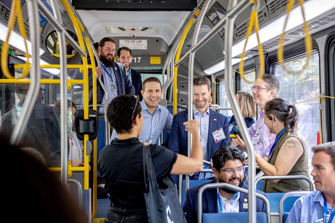 Tour participants sitting and standing inside of a metro bus