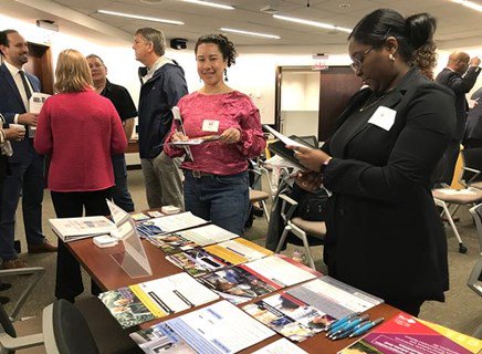 Enhanced Mobility Forum grantees visit an information table