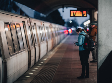 Two passengers waiting on the platform at a MD Metro station