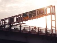 Woman walking on East Pennsylvania Avenue with interstate signs over head in Washington DC